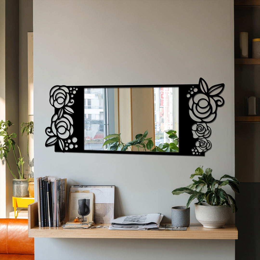 Showcasing a rectangular mirror with a black metal frame adorned with geometric rose motifs, exemplifying a blend of floral elegance and modern principles in decorating with wall mirrors.
