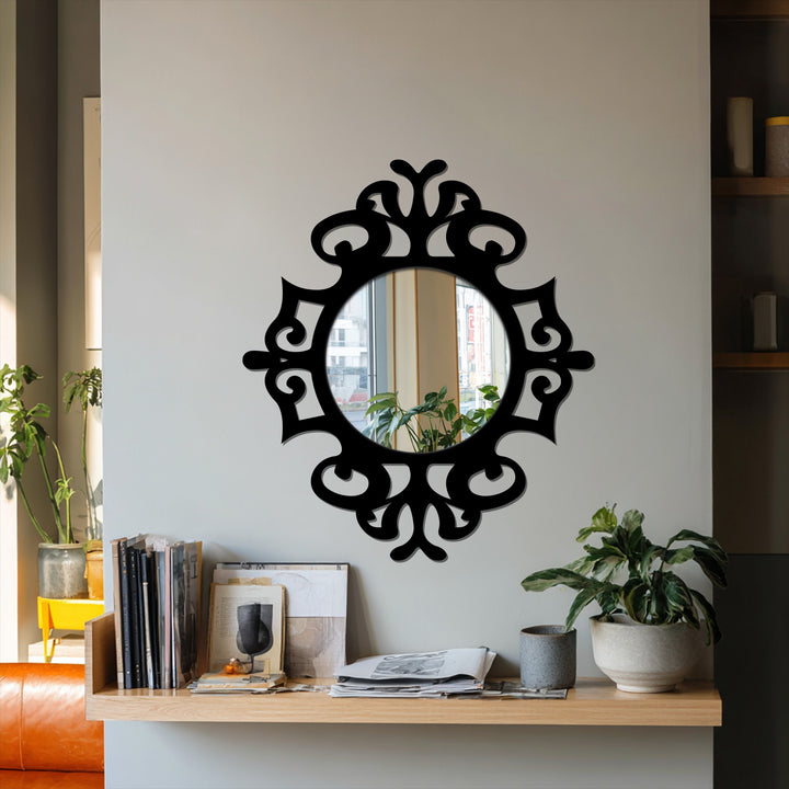 Reflecting the plant on the shelf, the focal point of the framed wall mirror is the ornate design surrounding the classic round shape.