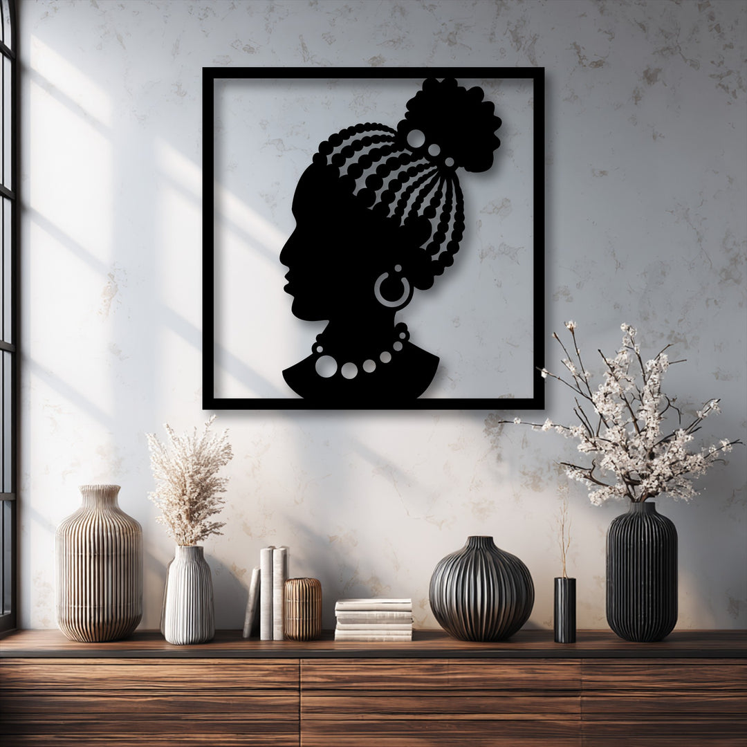 Striking color contrast in this African Woman Silhouette metal wall decor highlights the bold black artwork against a bright, textured wall.