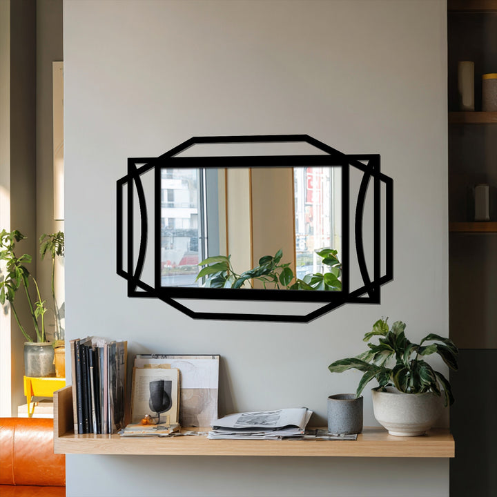 The stark color contrast highlights the black geometric frame of the Art Deco rectangular mirror for wall decor against a light wall.