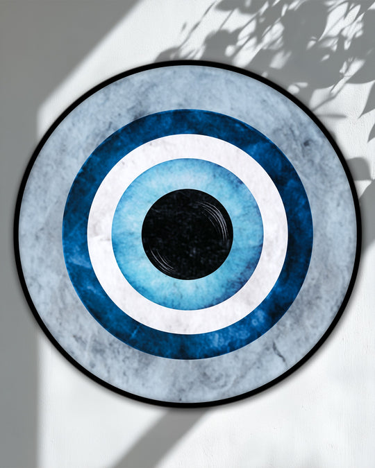 Negative space surrounds the blue evil eye symbol in this round canvas wall art, highlighting its minimalistic design among popular canvas wall art.