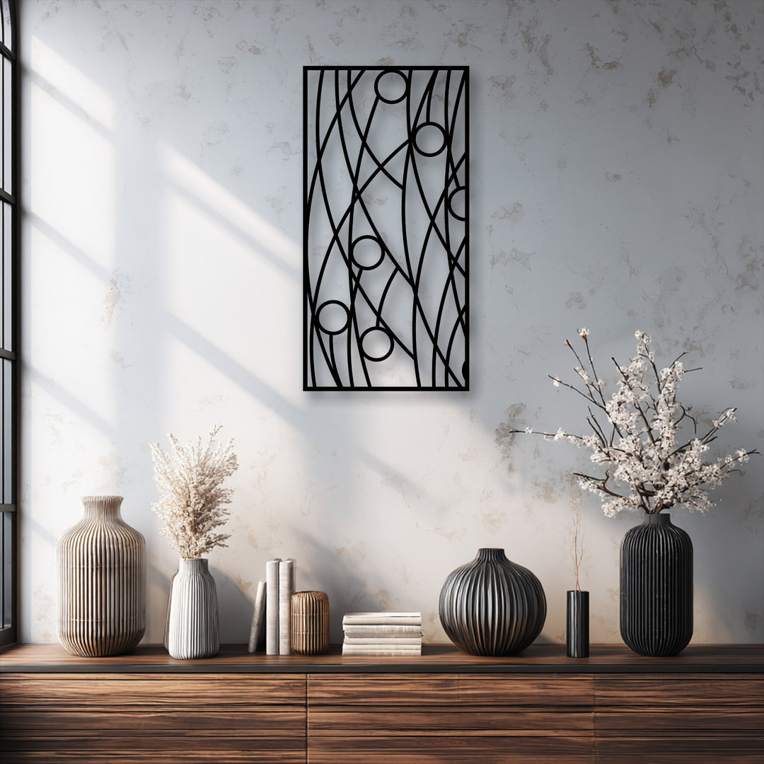 An abstract black panel of unique metal wall art with geometric lines and circles serves as a modern minimalist centerpiece.