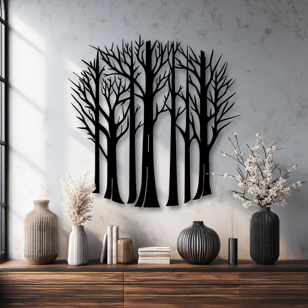 The mottled plaster texture of the wall provides a stark contrast to the smooth bare forest trees metal artwork, complemented by ribbed vases.