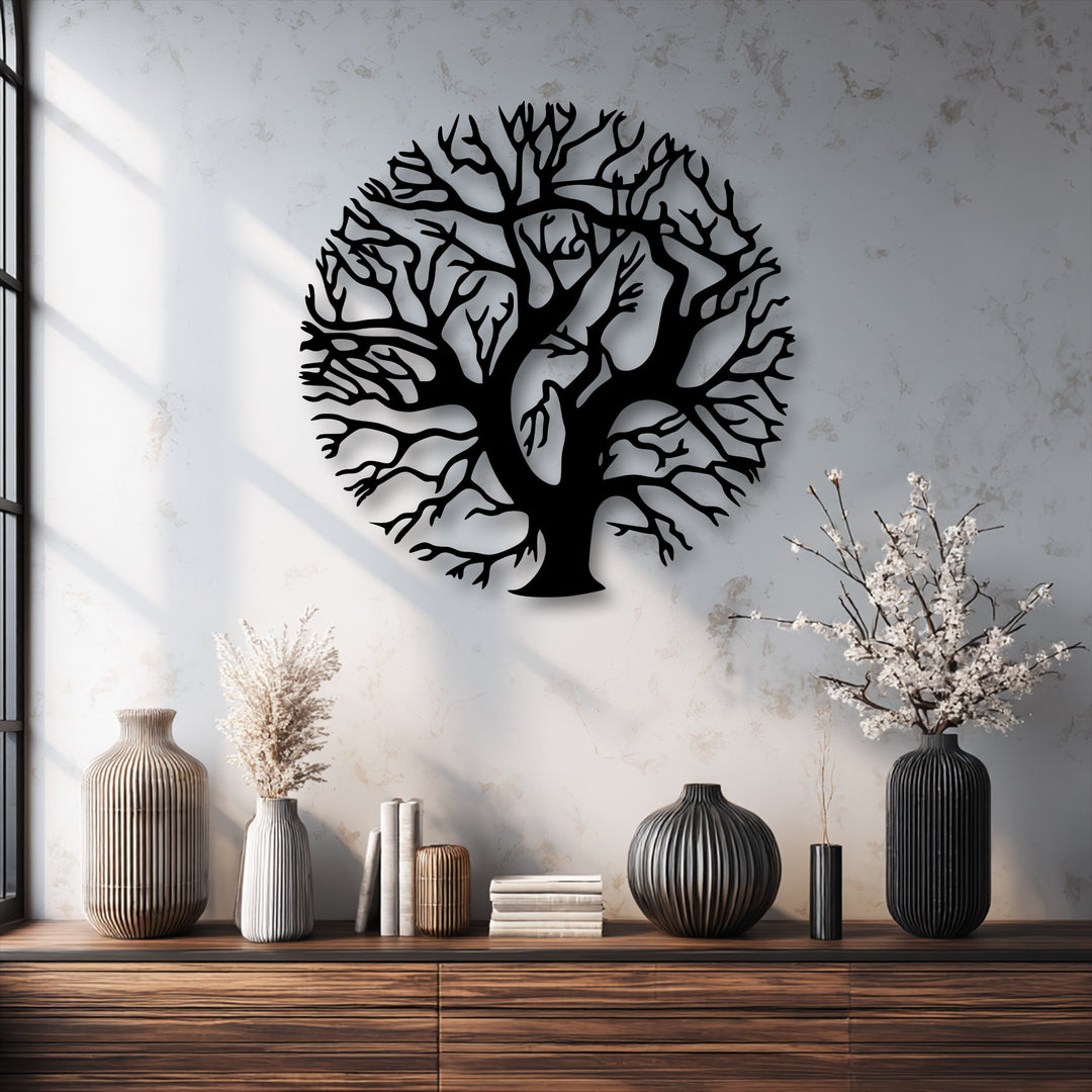 The brightest area, a sun-drenched, textured white wall, beautifully contrasts with the intricate black round Tree of Life decorative metal art.