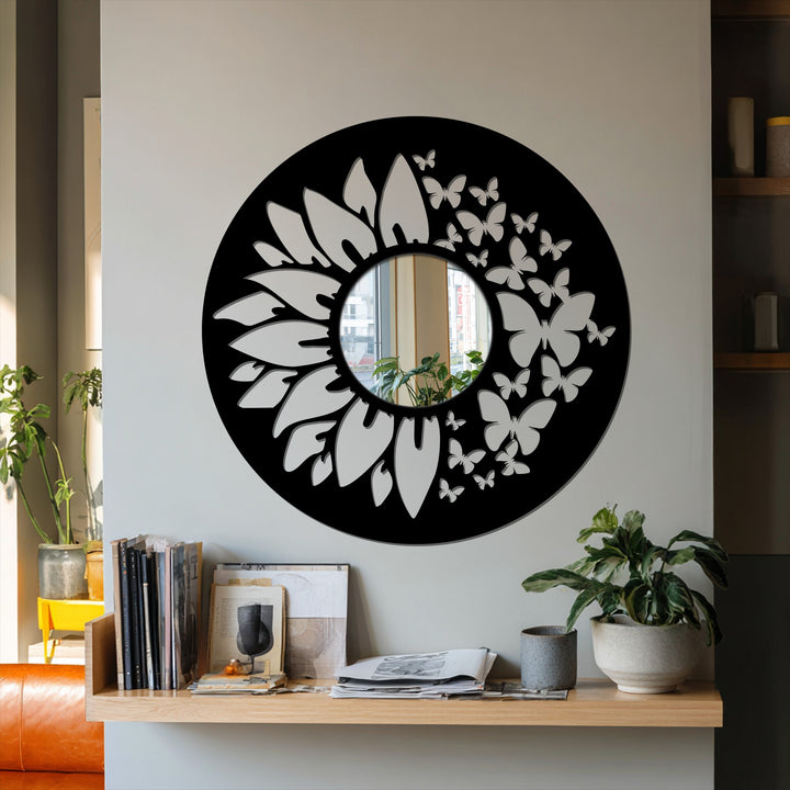 Round decorative bathroom mirror featuring a black metal frame with a butterfly and sunflower design is shown in a horizontal orientation.