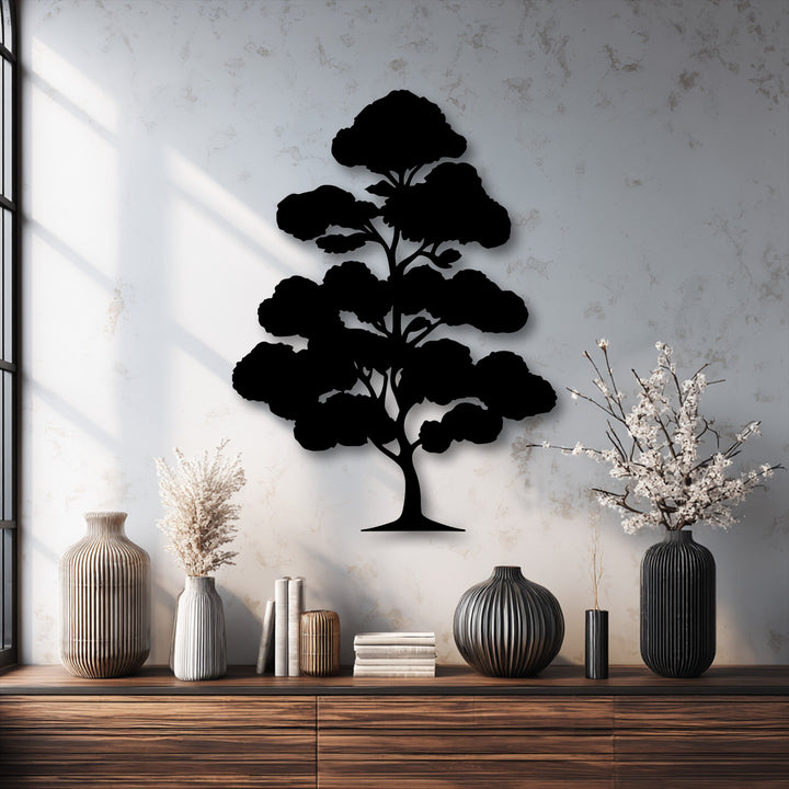 Vertically oriented metal art for wall depicts a stylized black bonsai tree silhouette with an organic shape and distinct foliage clusters.
