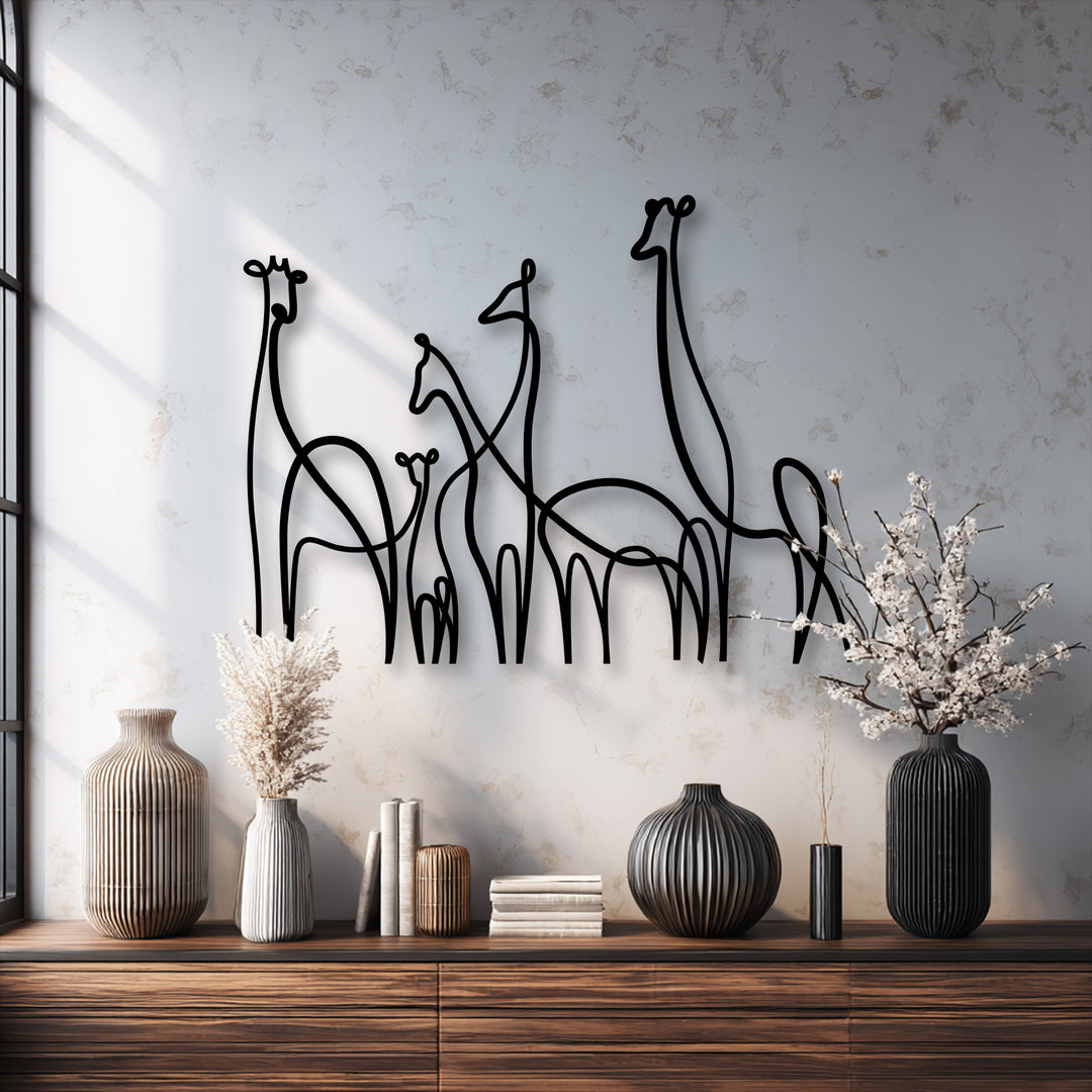 The distinct, clean edges of the minimalist giraffe family metal artwork trace the elegant line art figures.