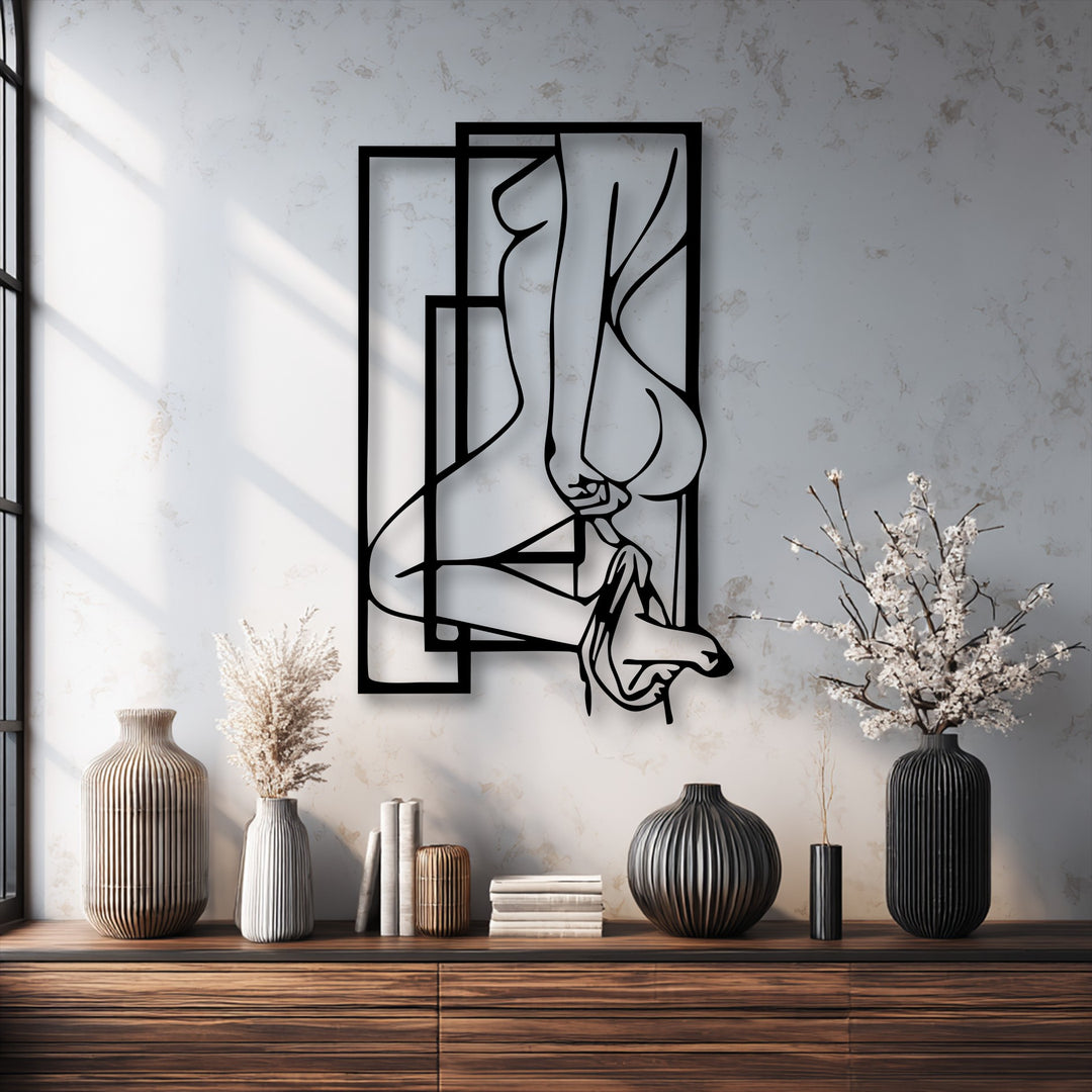 Highlighting the transition between the bold black abstract feminine silhouette metal wall decor and the varying soft hues of the textured wall.