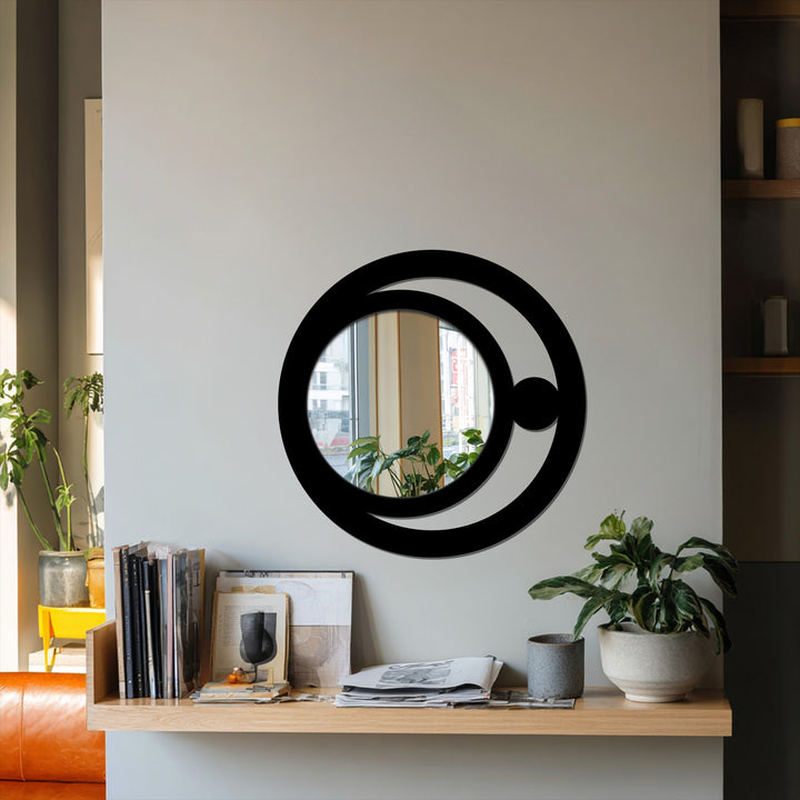 Reflected in the modern crescent orb wall mirror, the softest light lends depth to the minimalist design and celestial metal artwork surrounding the looking glass.