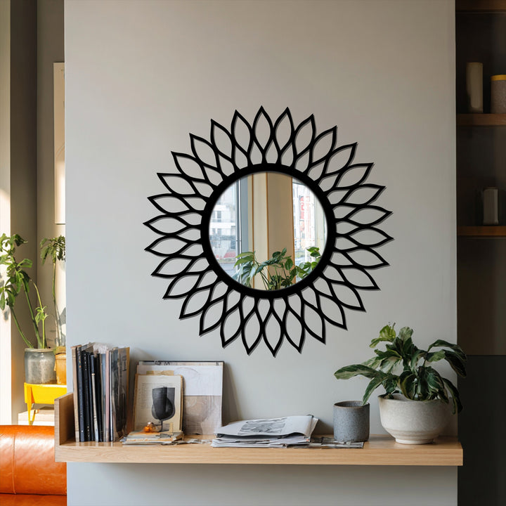 Negative space defines the floral pattern surrounding this round bathroom mirror, creating a radiant leaf halo design.