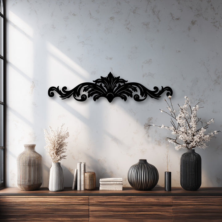 The visual rhythm of the elegant ornamental scroll metal artwork unifies the dark design with the ribbed textures of the vases on the wooden console.