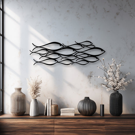 Flowing lines of minimalist abstract fish metal art for wall create a graceful sense of aquatic movement across the textured surface.