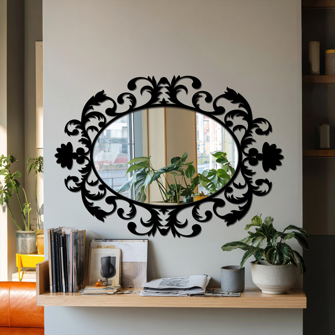 Against the light gray wall, the ornate scrollwork oval mirror reflects a bright window and plants, exemplifying decorating with wall mirrors for interior design.