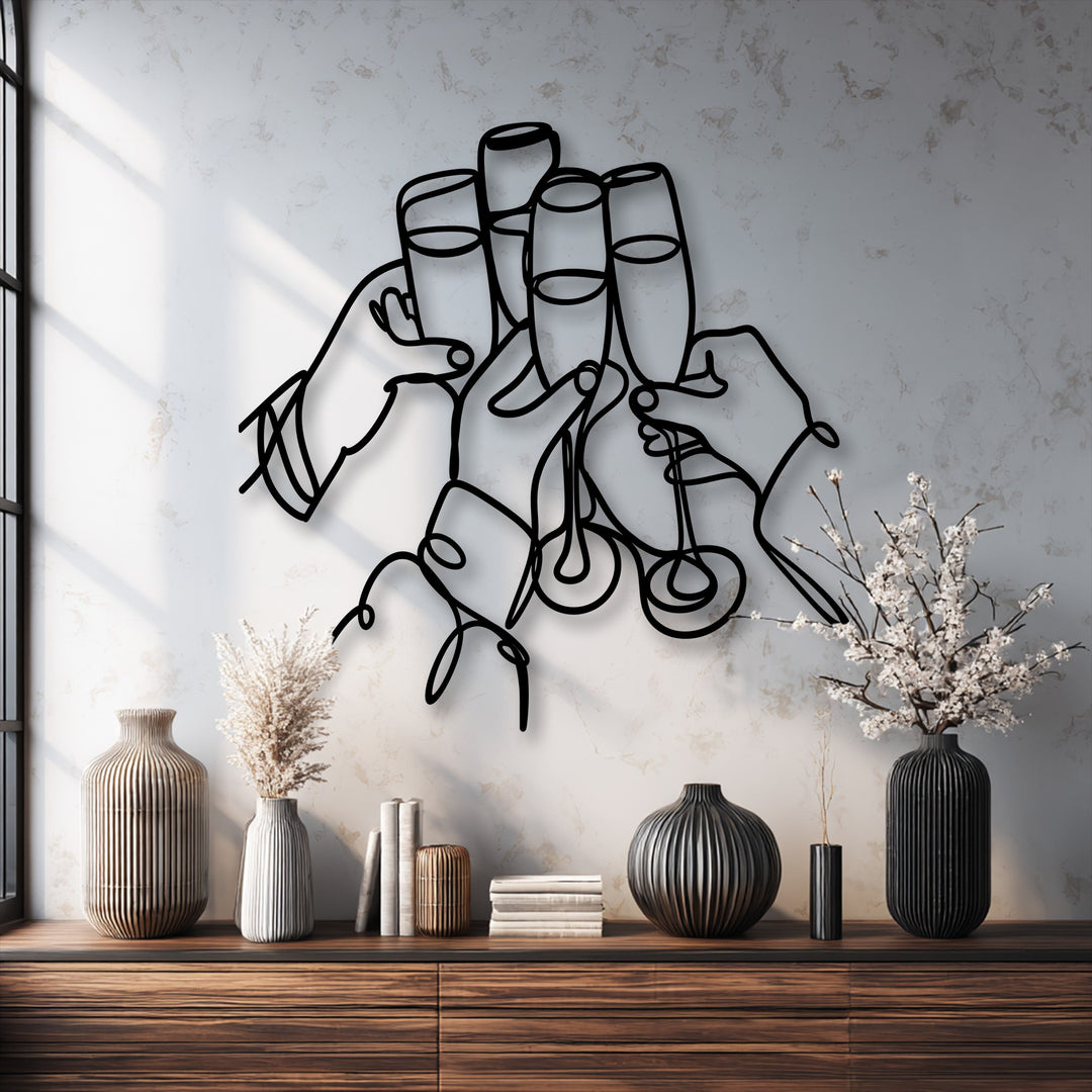 The stillness of the celebratory metal wall decor captures a Cheers Moment, depicting line art hands toasting with champagne flutes.