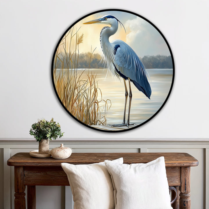 Subtle light and shadow play across the 'Still Waters – Majestic Heron at Sunrise' oil painting artwork, highlighting the calm lake and elegant bird.
