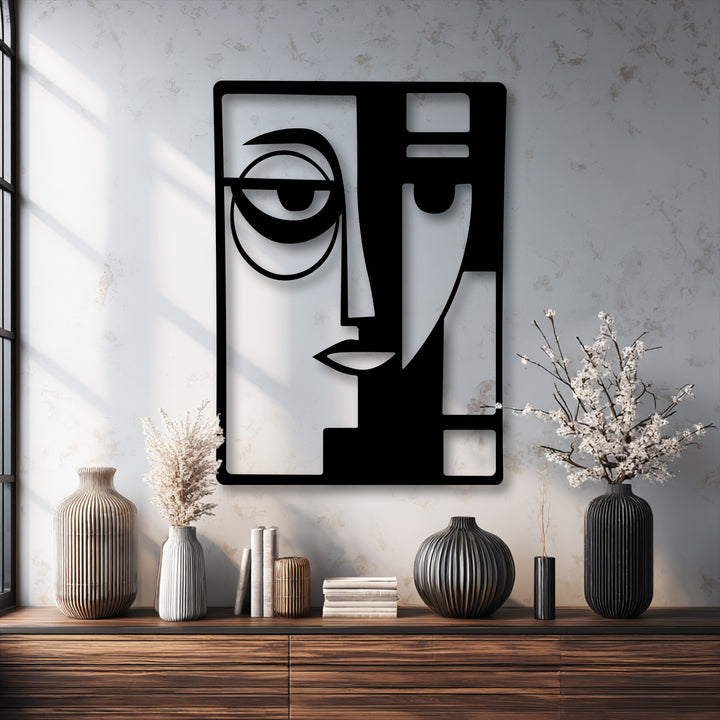 The striking geometric elements of the black abstract dual face metal art for wall feature stylized eyes and angular lines, creating a modern design.