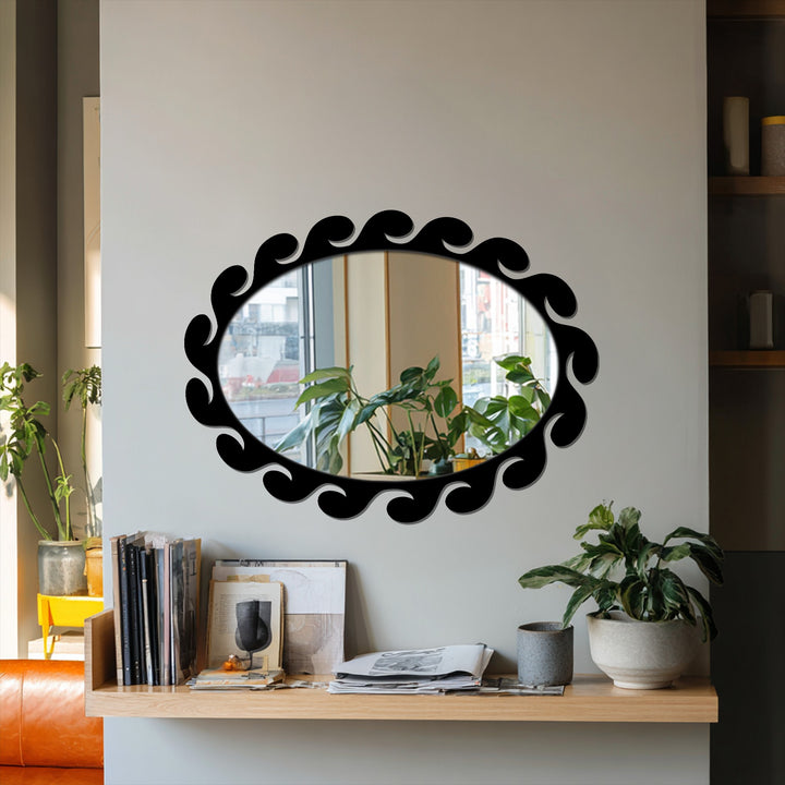 Play of light and shadow emphasizes the sculpted wave pattern of the fluid, black-framed decorative mirror, reflecting the room's subtle luminosity.