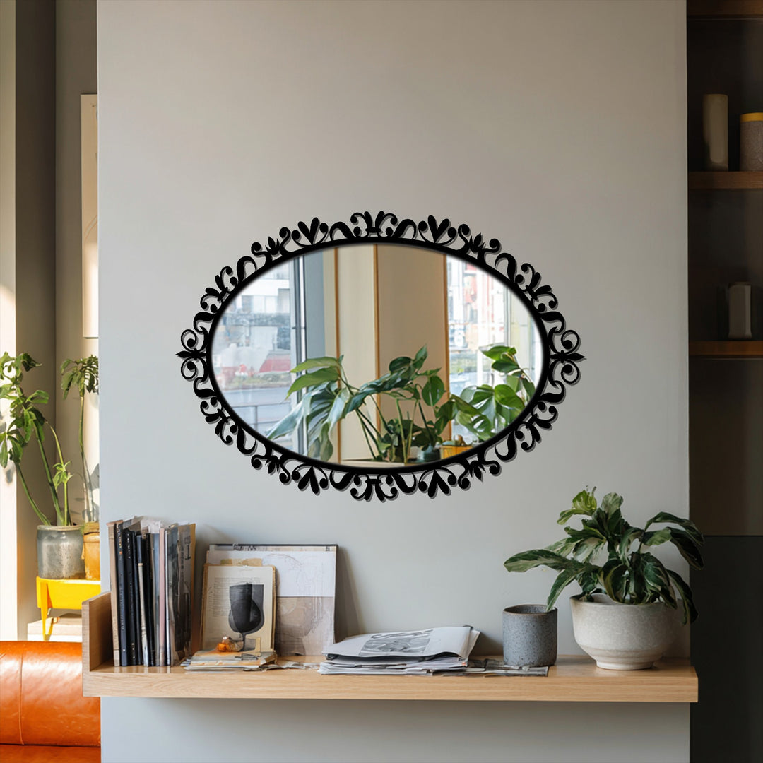 Subtle light and shadow play across the wall, enhancing the ornate scrollwork metal frame of this decorative oval modern mirror.