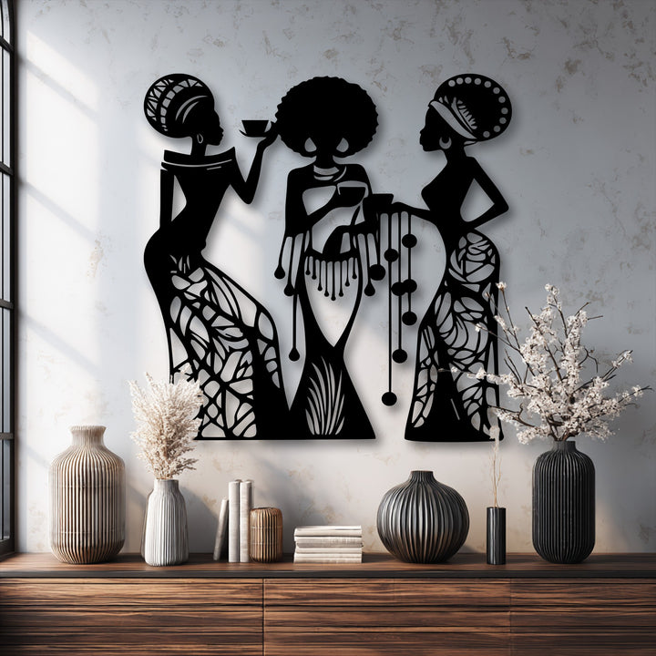 The graceful movement of three women silhouettes, captured in intricate decorative metal art, evokes a dynamic, flowing narrative.