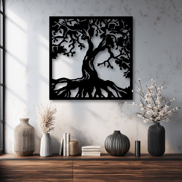 The central subject is a striking black tree silhouette decorative metal art, featuring intricate branches and deep, spread roots.