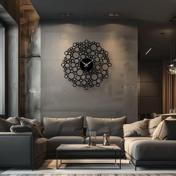 The focal point is the decorative metal art of a modern geometric design bubble mesh metal wall clock, hung as wall art in an interior setting.