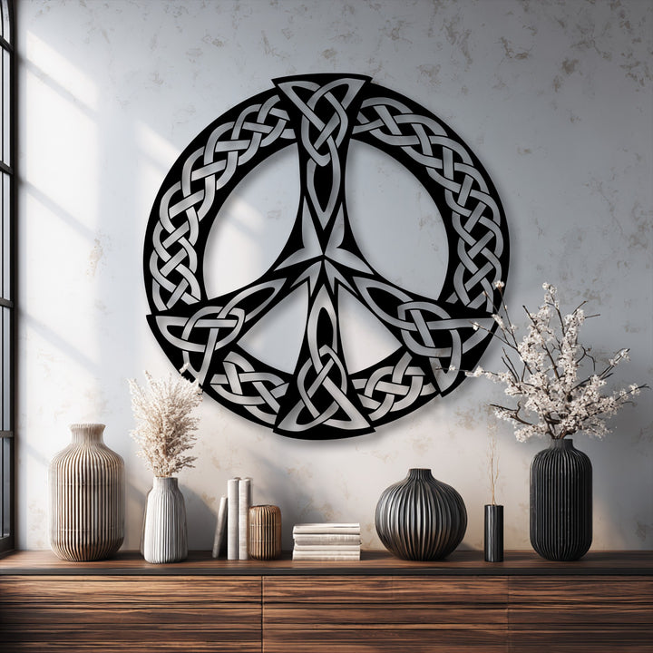 The foreground presents a wooden dresser holding fluted vases, books, and dried florals, providing a warm base for the stunning metal art for wall.