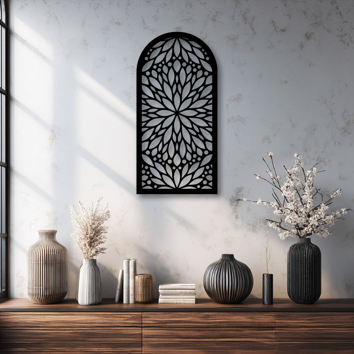 The abstract quality of the black arch metal wall decor is defined by its intricate mandala-inspired floral pattern, creating a striking visual.