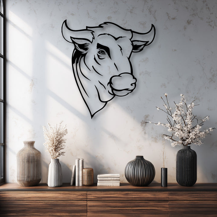 Showcasing significant depth and layers, a minimal line bull head metal art for wall casts a prominent shadow on the textured wall.