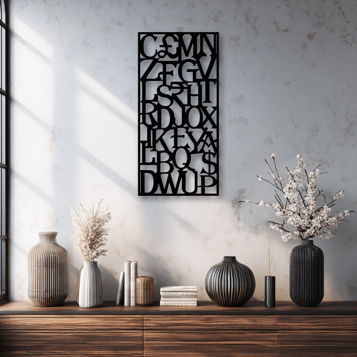 The matte black finish of the intricate laser-cut abstract alphabet grid metal wall decor creates a striking modern typography statement.