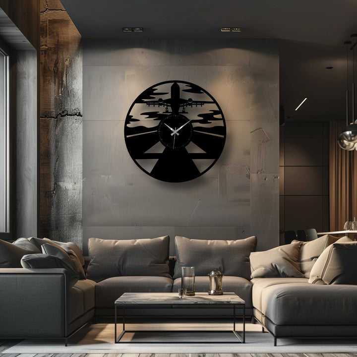 A striking circular black airplane silhouette decorative metal art wall clock is the central subject, featuring an airplane taking off over a runway.