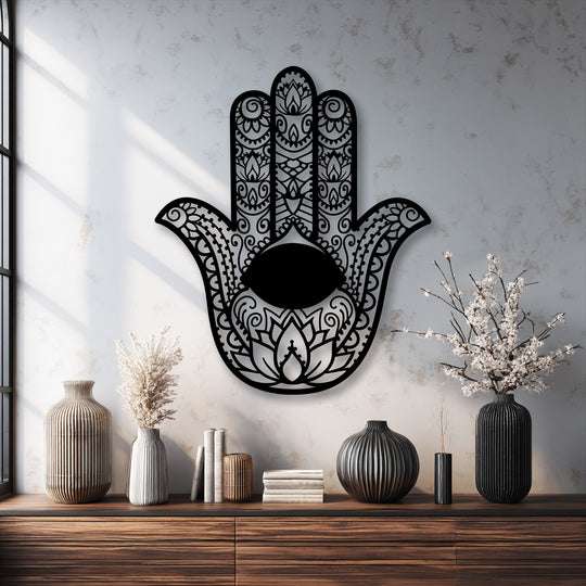 Light grey decorative metal art featuring an intricate black Hamsa Hand with Evil Eye symbol on a textured wall.