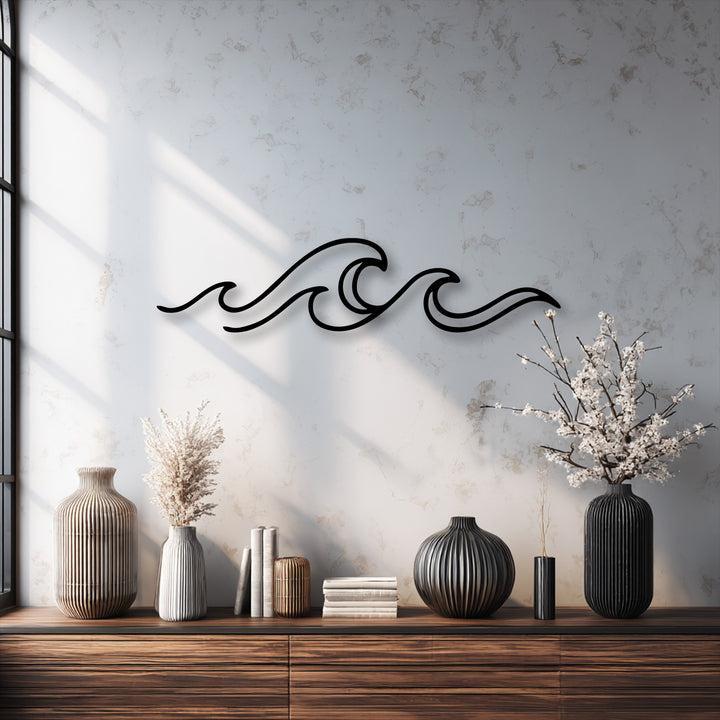 The darkest area prominently features the elegant black Minimal Ocean Wave Line Metal Wall Art, alongside dark vases, as a unique metal wall art piece.