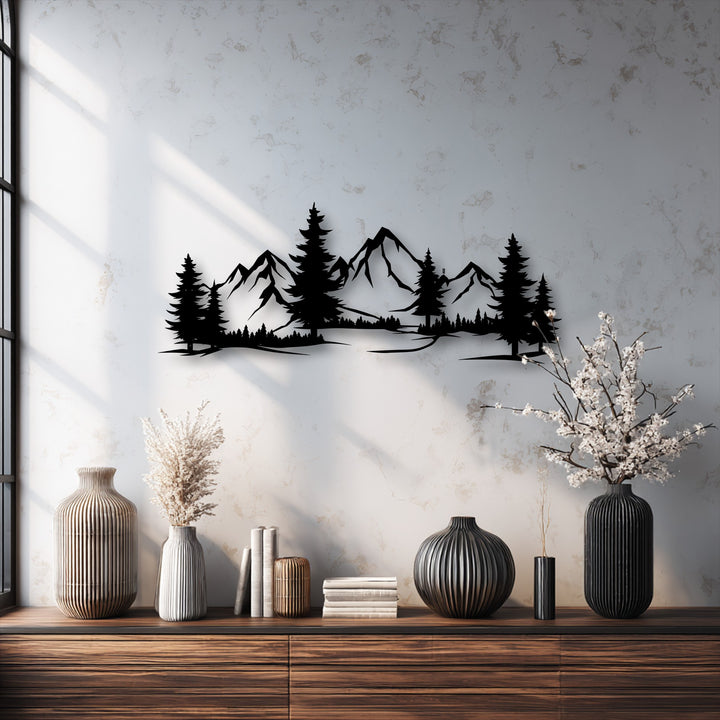 The focal point is an intricate black metal art for wall depicting a striking mountain forest landscape with detailed pine trees and peaks.