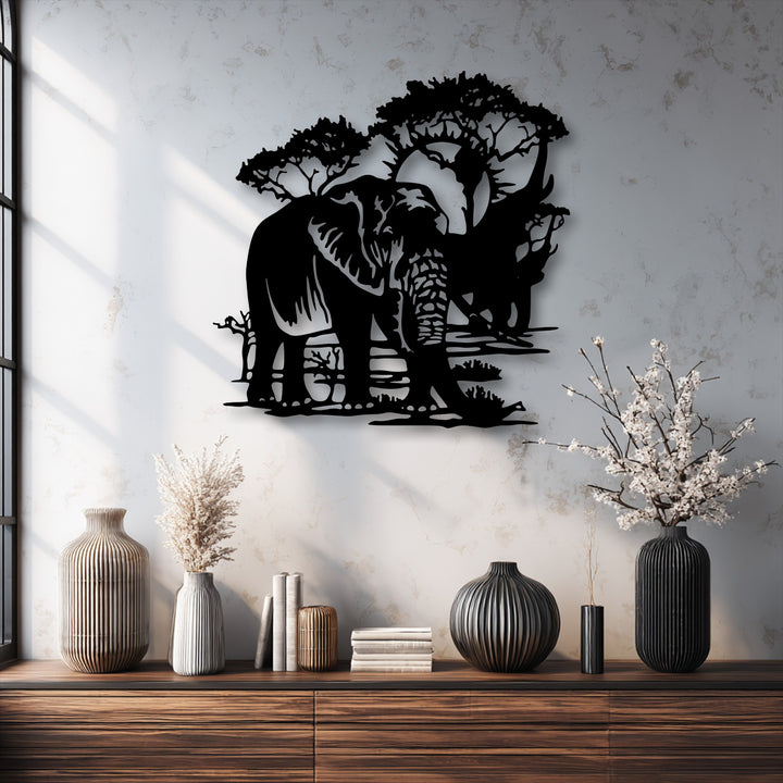 The warm color temperature highlights the intricate Majestic Safari elephant landscape metal artwork and the subtle textures of the wall.
