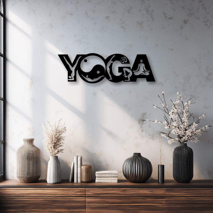The bold black Yoga Balance Flow metal wall decor creates a stark color contrast against the bright, textured wall above a warm wooden surface.