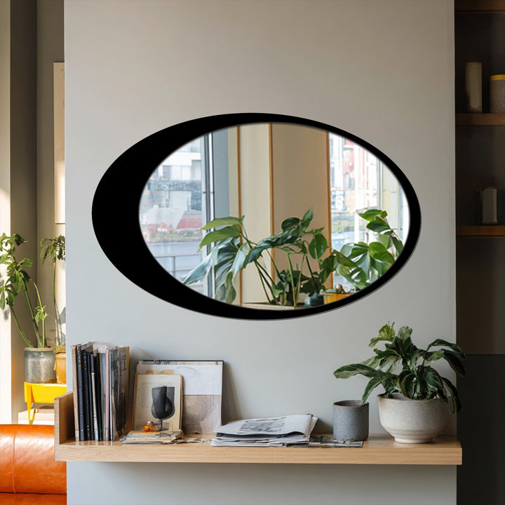 Horizontally oriented oval mirror for wall decor featuring a sleek black frame.