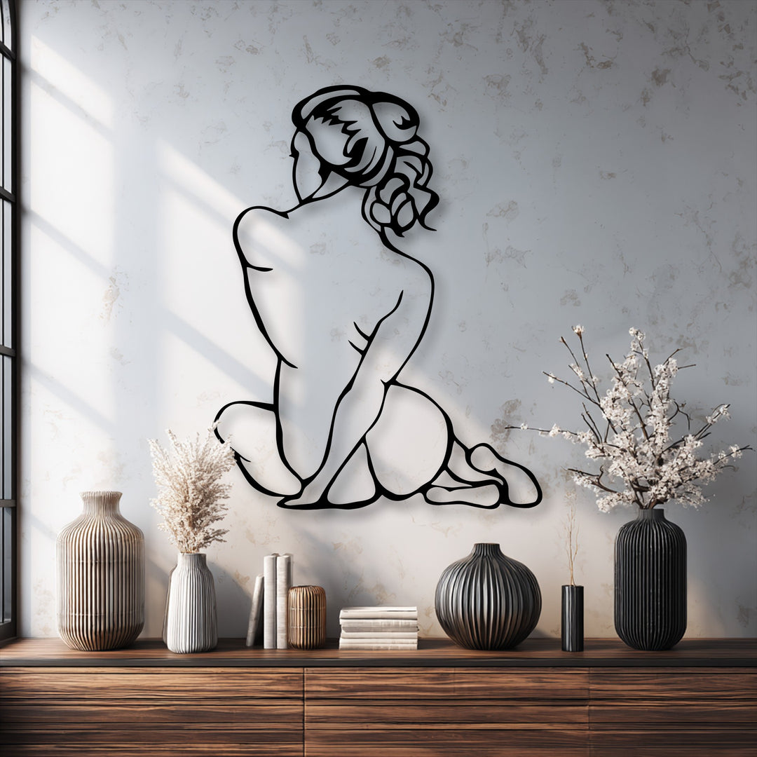 The light grey textured wall background, featuring subtle window shadows, beautifully highlights the elegant minimal female figure metal art for wall.