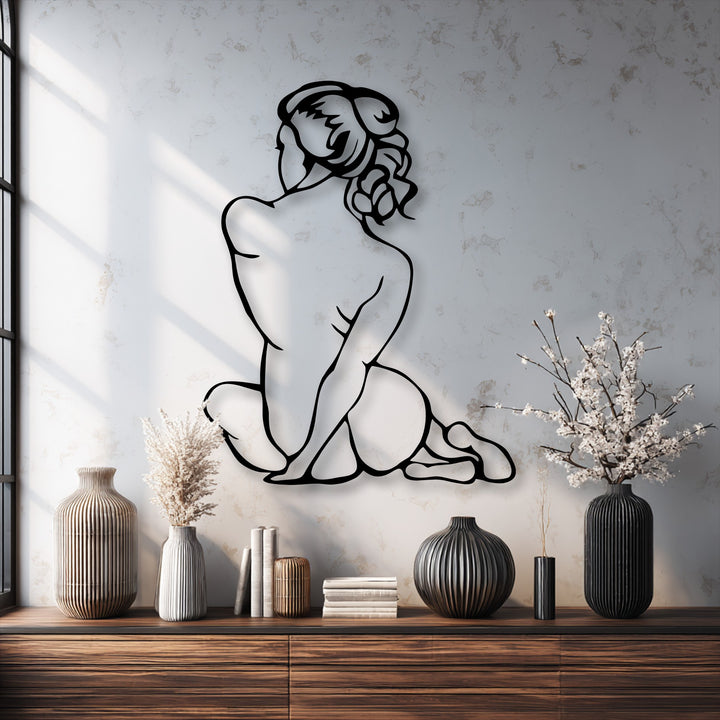 The light grey textured wall background, featuring subtle window shadows, beautifully highlights the elegant minimal female figure metal art for wall.