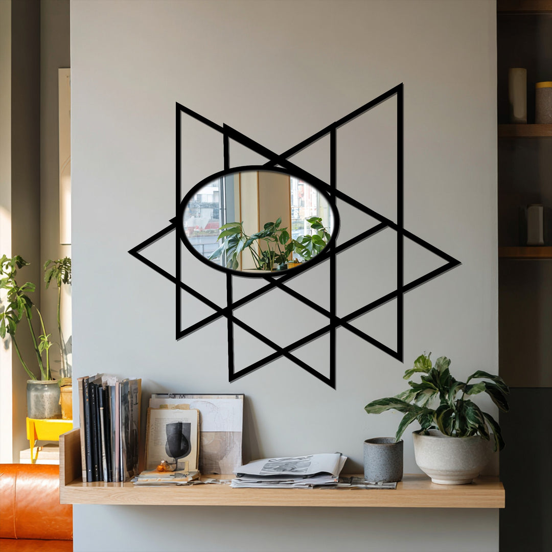 Black dominates this geometric oval floor mirror's design, a striking piece of metal artwork featuring intersecting triangles and a reflective surface.