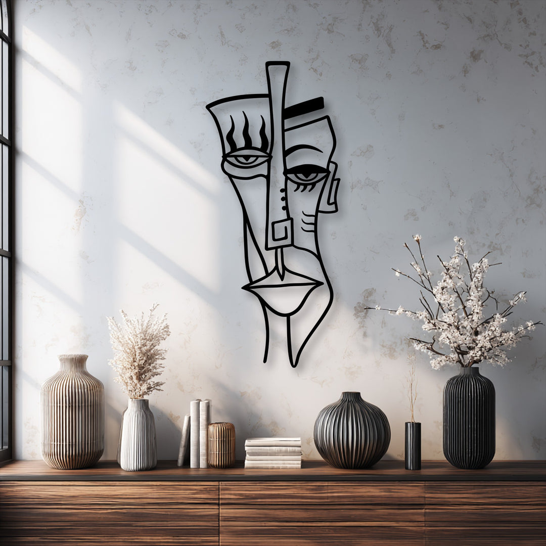 The crisp, clean edges of this unique metal wall art trace the striking, modern lines of the abstract tribal face mask.