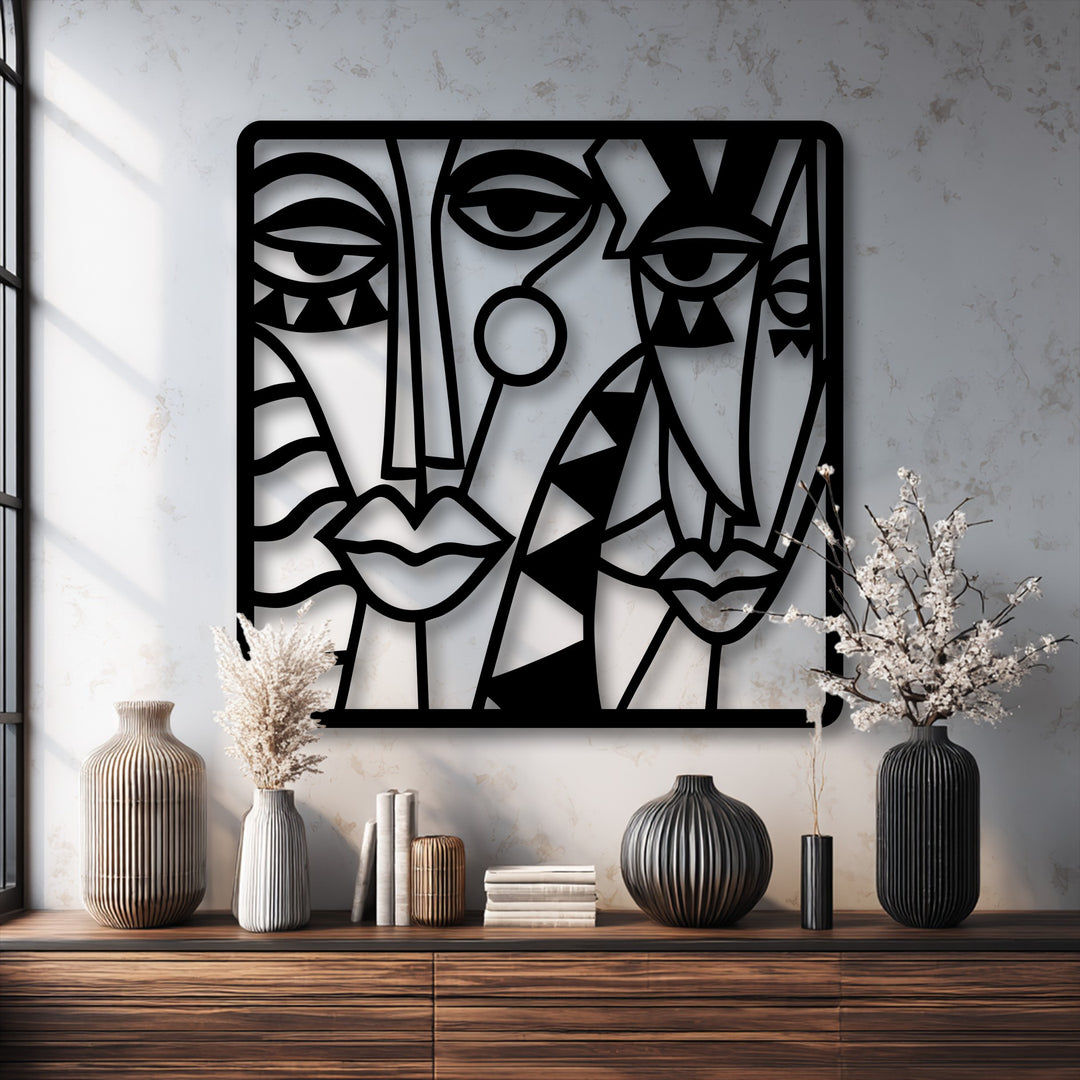 Negative space skillfully outlines the abstract cubist faces in this black metal decoration wall art, emphasizing the striking design.