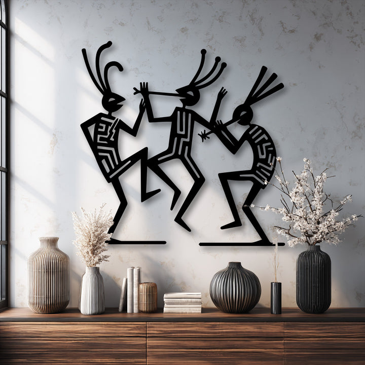 Matte black finish on metal art for wall showcases tribal dance figures with intricate geometric cutouts, providing cultural rhythm decor.