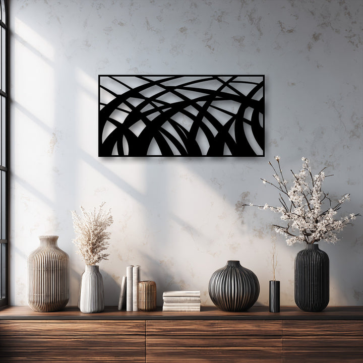 Organic forms are highlighted in this unique metal wall art with abstract flowing lines, complemented by striated vases and delicate blossoms.