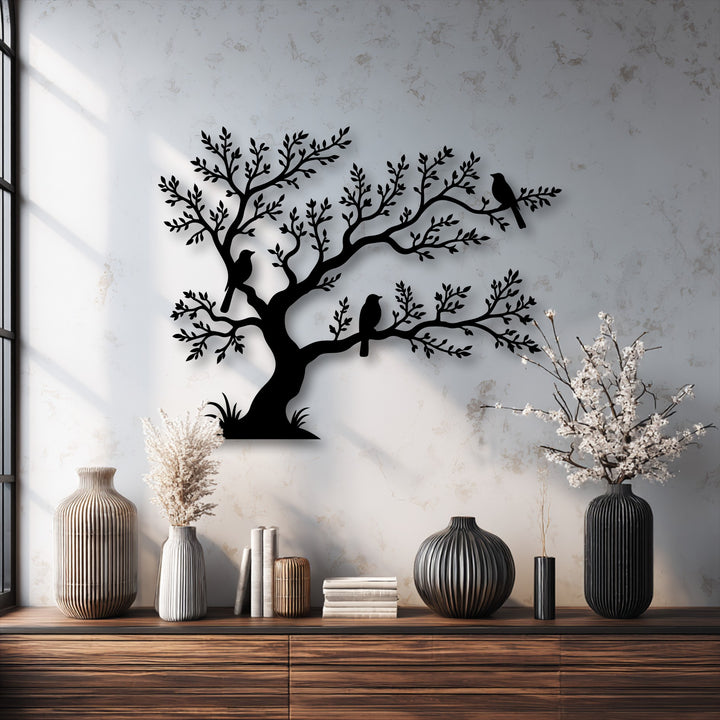 The elegant layering effect of the decorative metal art featuring birds on a tree creates compelling depth and dimension on the wall.