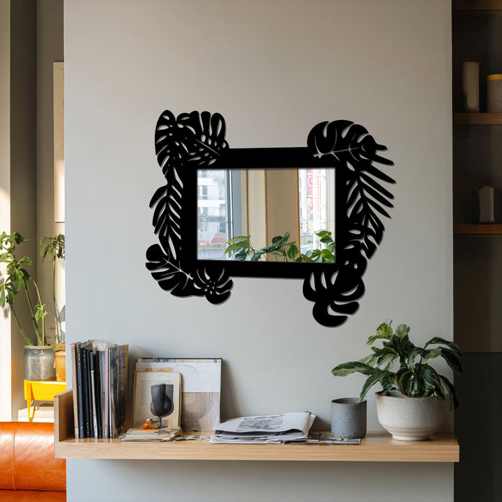 Highlighting the reflection of the outdoor scenery, this framed wall mirror features a tropical leaf metal frame, creating a botanical statement for unique metal wall art.
