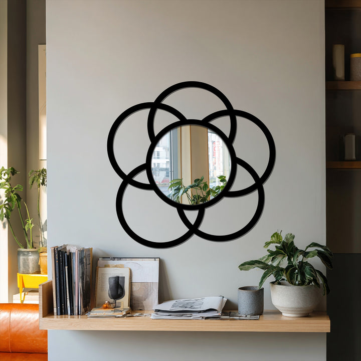 Subtle surface texture emphasizes the interlocking circle frame of this modern decorative mirror, enhancing its geometric design with a refined, artistic touch.