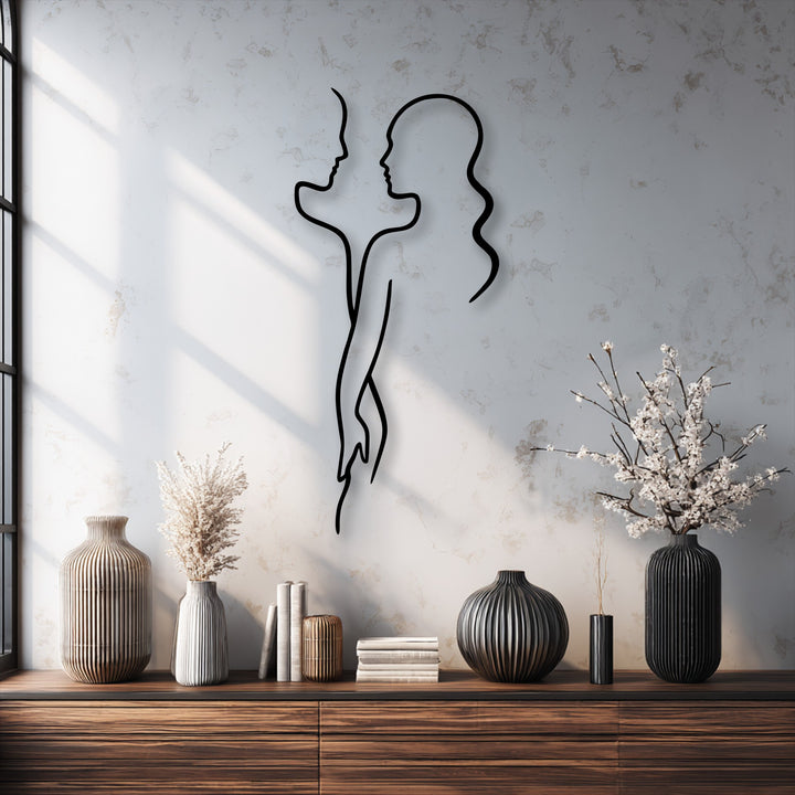 The distinct layering effect of a unique metal wall art piece, a minimal couple love silhouette, casts a striking shadow on a textured wall.