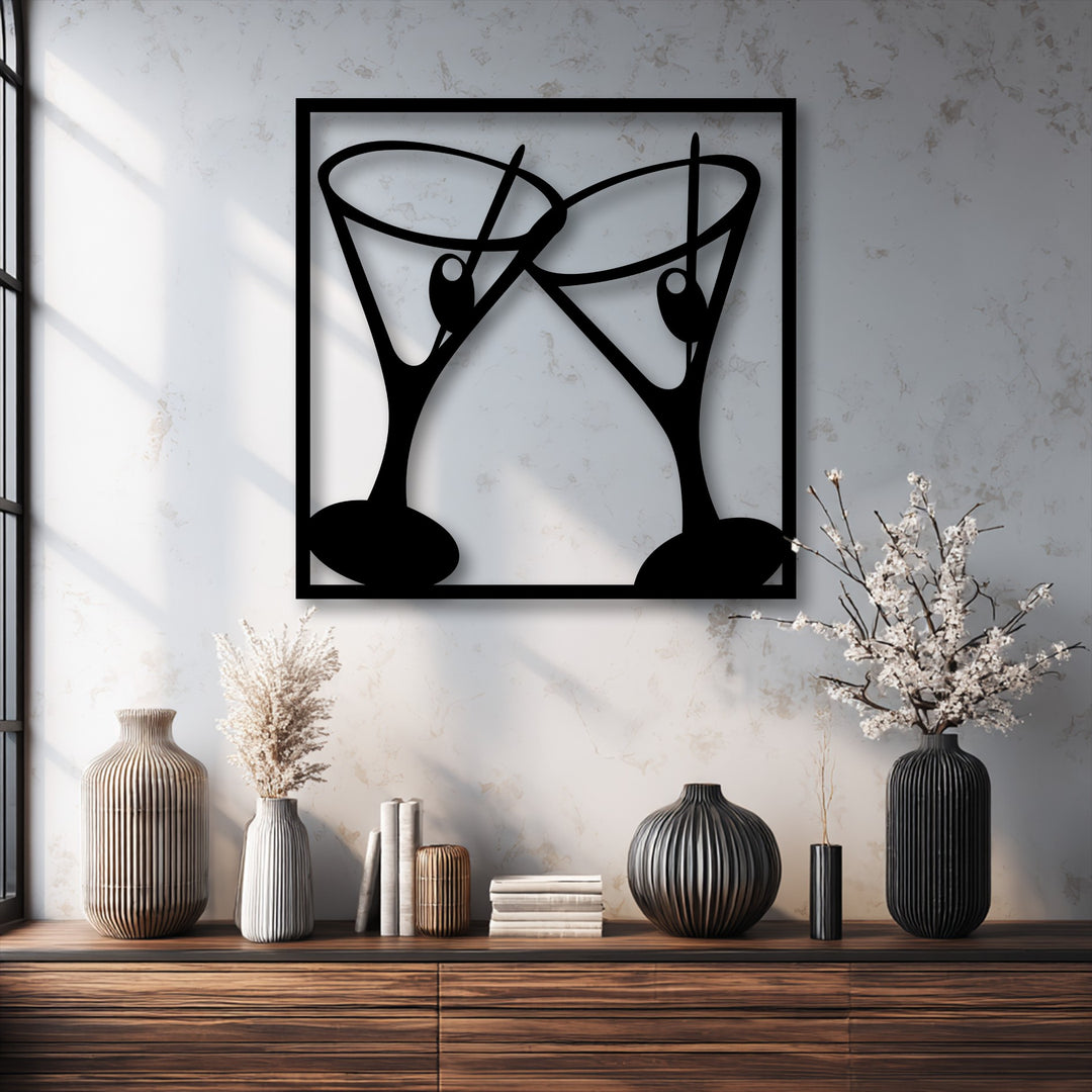 The decorative metal art piece captures the dynamic moment of two cocktail glasses clinking in a modern bar setting.