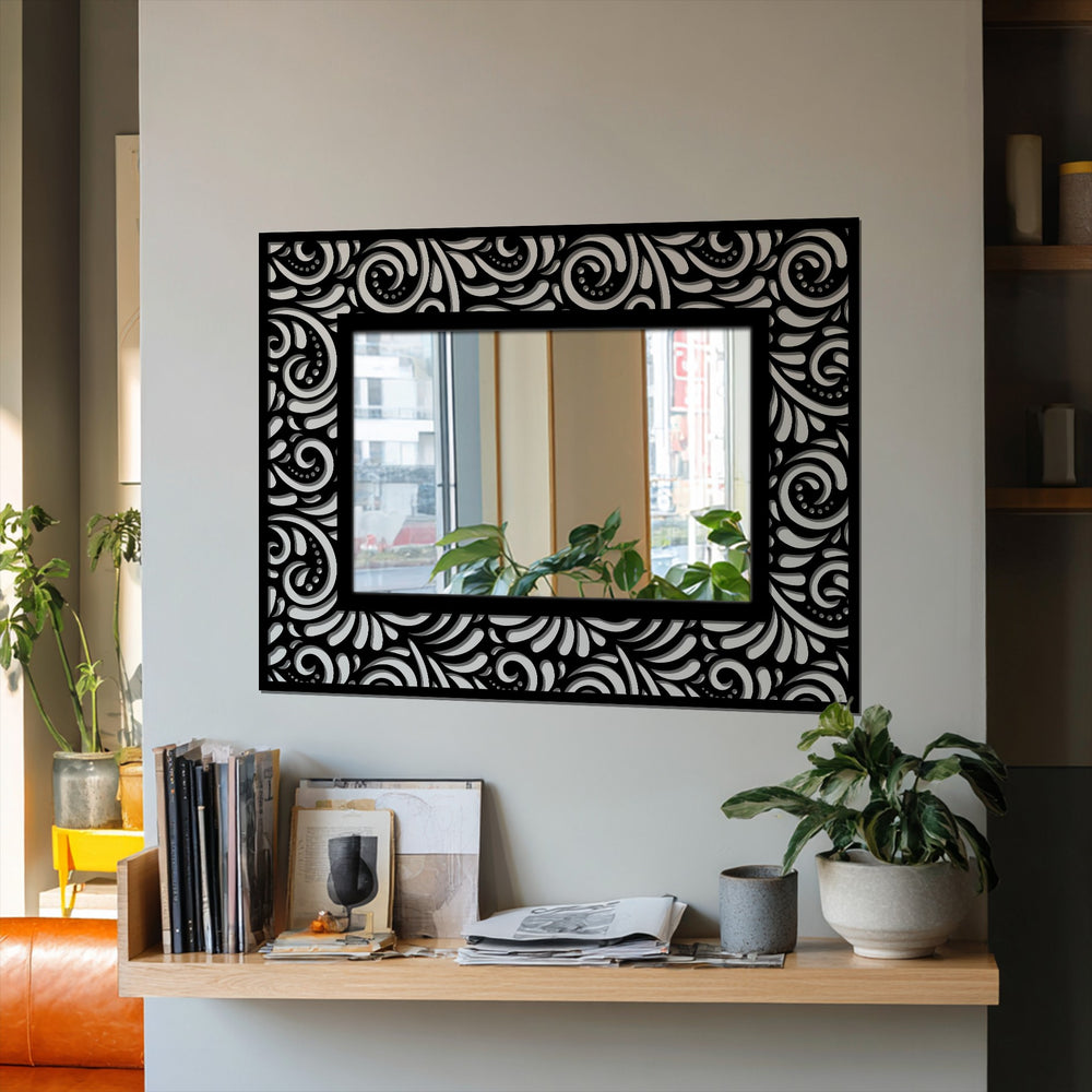 The organic forms of the ornate floral scroll design adorn the black frame of this rectangular stained glass wall mirror, providing a visually appealing centerpiece.