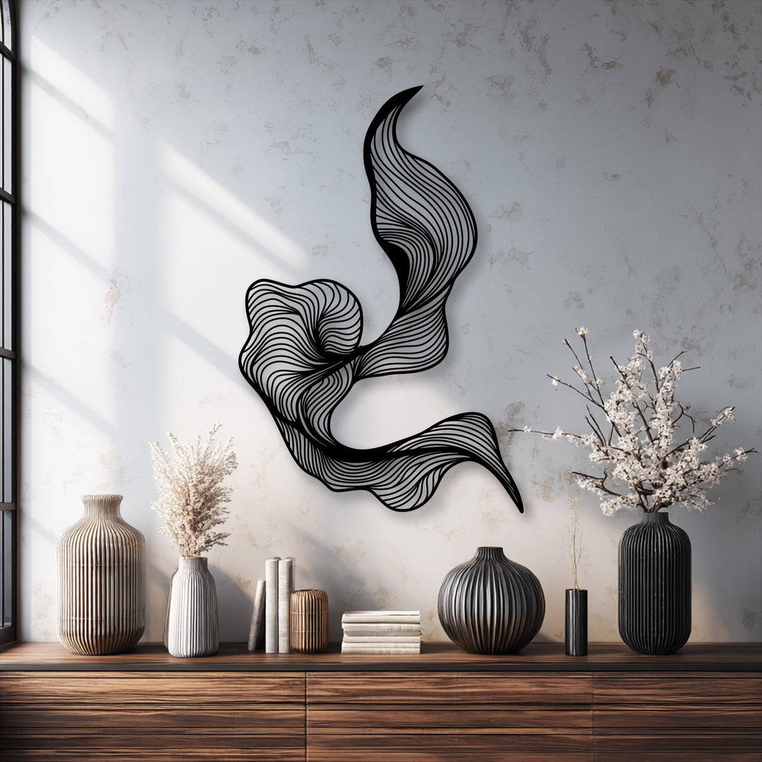 The layered black metal wall decor creates an intricate abstract flow with its fluid line design, casting dynamic shadows on the white wall.